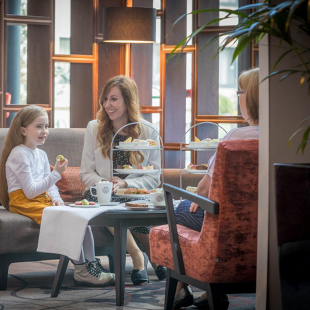 child, mother and grandmother sitting having afternoon tea in Whites of Wexford