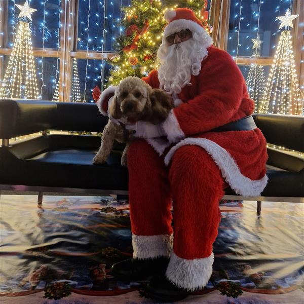 Santa sitting with his dog at Santa's Enchanted Christmas Enniscorthy