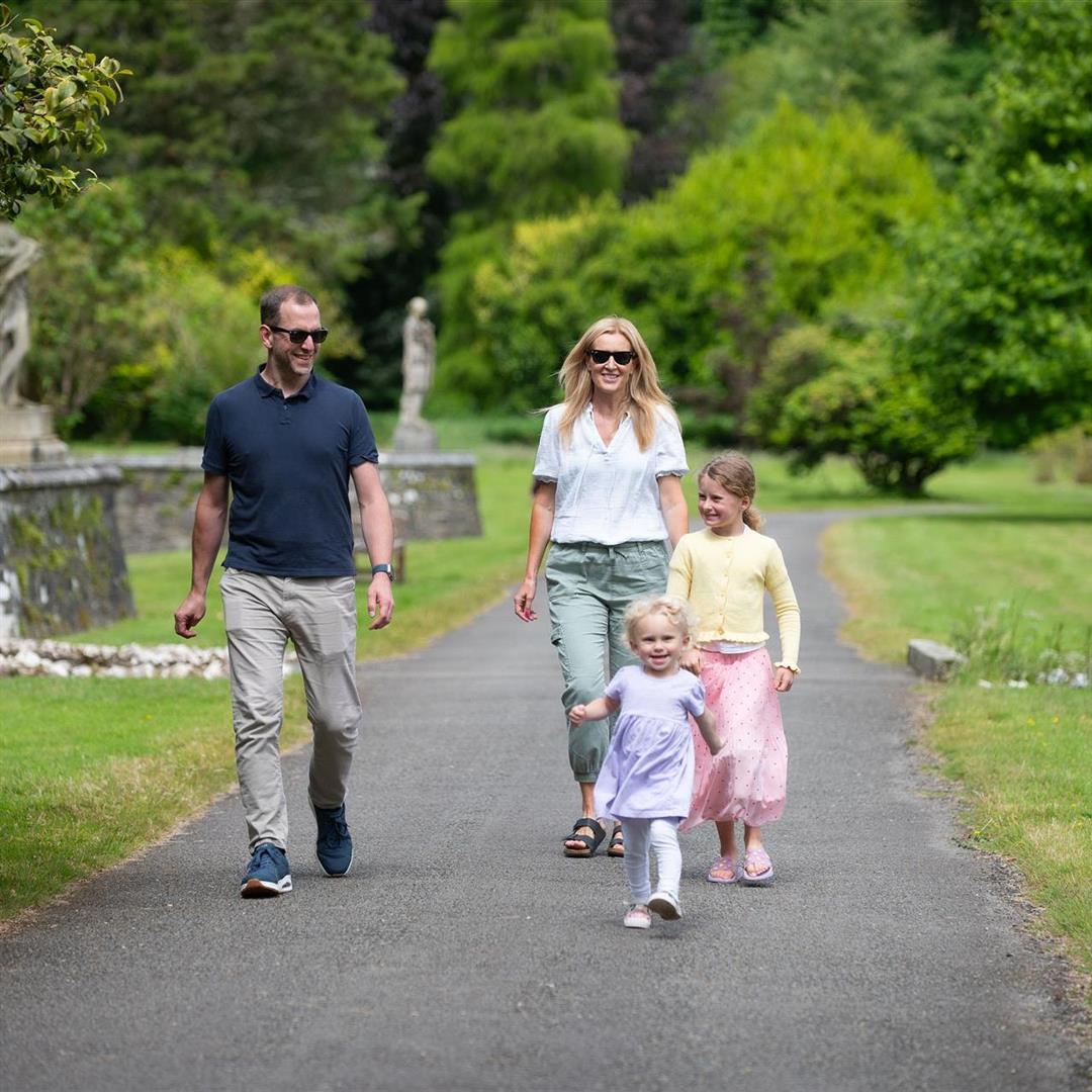 two young children walking with parents in Johnstown Castle Gardens